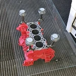 Rectangular Glass Coffee Table With Red Silver Engine Block Metal Base. Fixed Price $699.99.